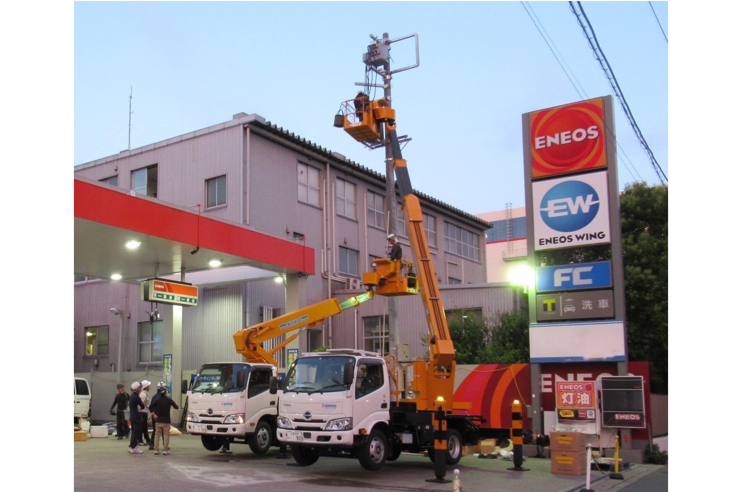 東京都江東区にあるENEOSのEVトラック対応の商用車向け共用充電ステーションに柱上高圧受電装置を取り付け工事中の様子